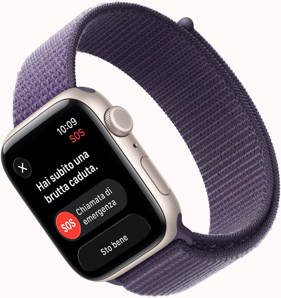 Apple Watch SE 3, cassa in alluminio color galassia, notifica SOS Rilevamento cadute, pulsanti Chiamata di emergenza e Sto bene, lato destro, Digital Crown, microfono, tasto laterale, cinturino Sport viola nebbia