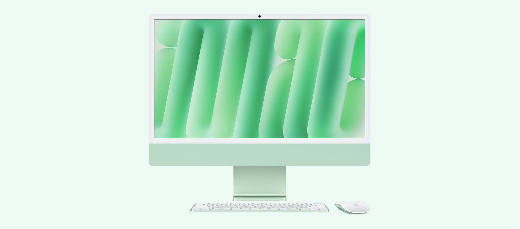 Vista frontal de una iMac verde con mouse y teclado a juego