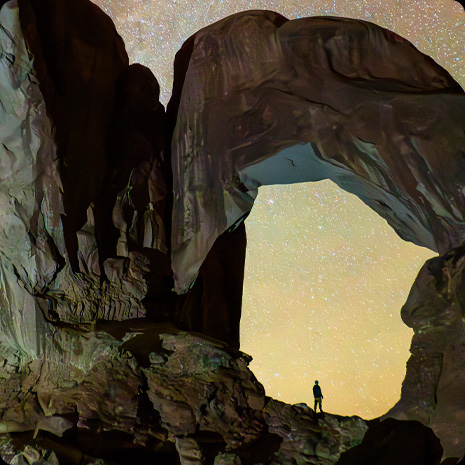 iPad Pro, front exterior, display showing a photograph of a person in a canyon and a star-filled night sky