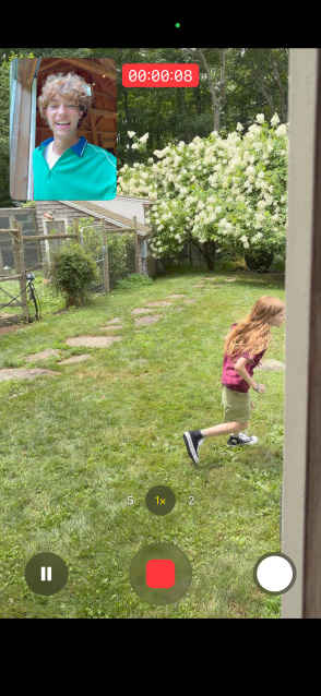 iPhone 17 screen using front and rear camera Dual Capture video of child running while adult watches