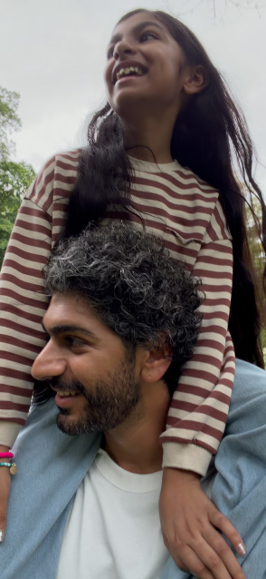 iPhone 17 screen demonstrating stabilised video recording as man carries girl on his shoulders